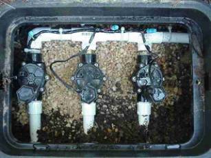 Open irrigation box showing valve manifold